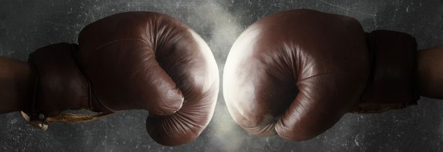 two boxing gloves facing each other