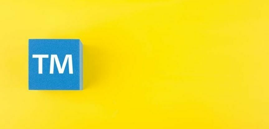 trademark sign on blue box and yellow background